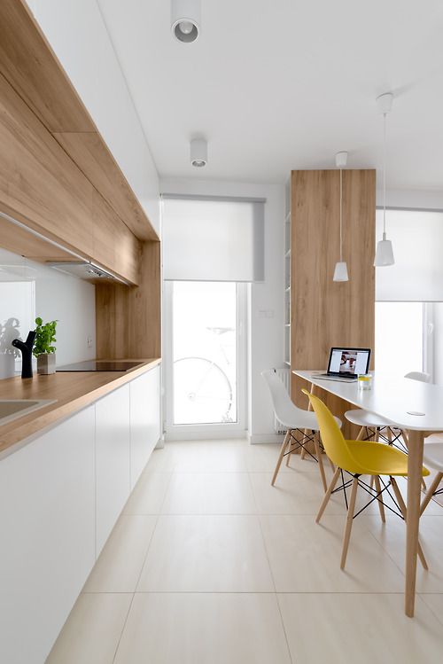 02-a-modern-white-kitchen-with-wooden-counters-and-some-cabinets-for-more-coziness.jpg