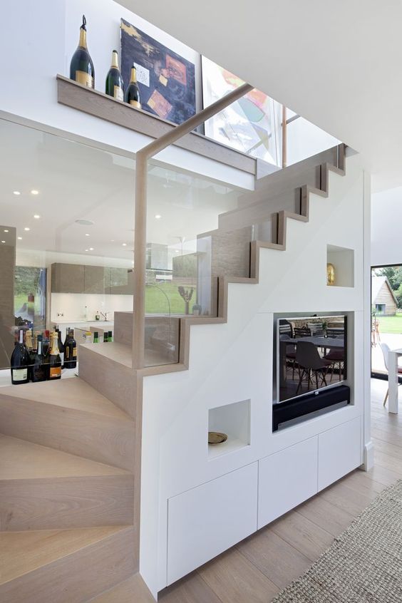a-couple-of-niches-and-a-TV-built-in-under-the-stairs-to-avoid-using-any-floor-or-shelf-space-for-these-items.jpg